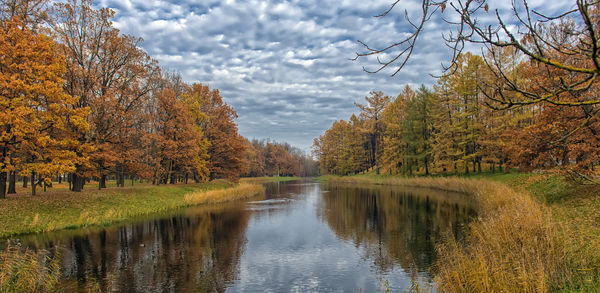 Scenic view of lake by trees against sky during autumn