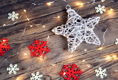 High angle view of illuminated christmas decorations on wooden table