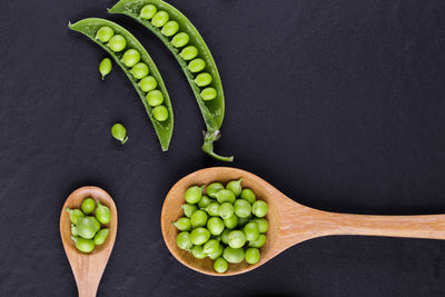 Directly above shot of green fruits against black background