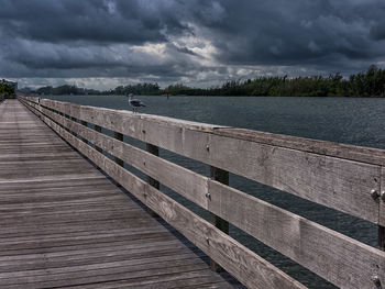 Pier over lake against sky