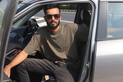 Midsection of man sitting in car