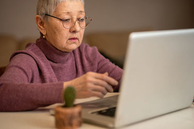 Portrait of man using laptop on table