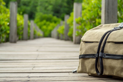 Bag on boardwalk against trees