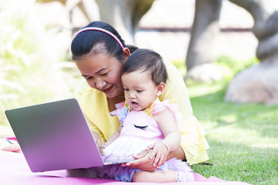 Mother and daughter using mobile phone