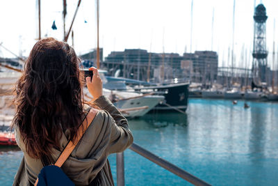 Woman by sea against sky