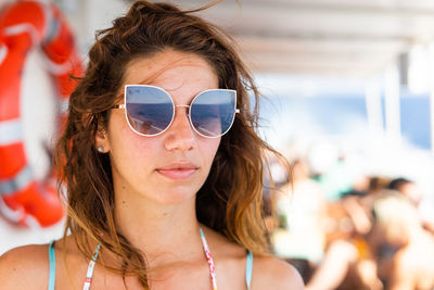 Woman wearing sunglasses standing in boat