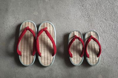 Directly above view of flip-flops on concrete floor