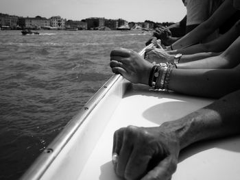 Cropped hands in boat on river