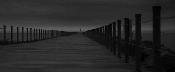 Wooden railing against sky