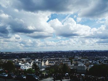 High angle view of city against cloudy sky