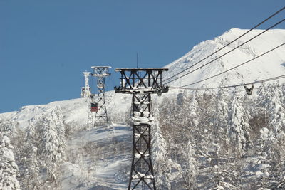 Snow covered mountain against clear blue sky