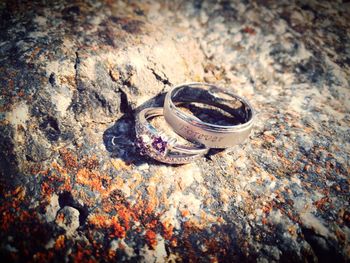 Close-up of wedding rings on rock