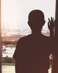 Rear view of silhouette woman against sky