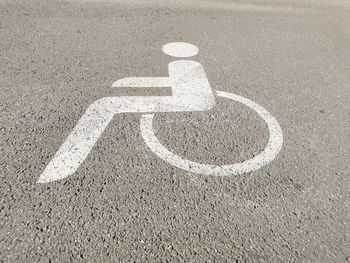 High angle view of handicapped parking sign on road