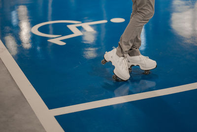 A girl skater at the disable parking