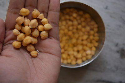 High angle view of hands holding chickpeas