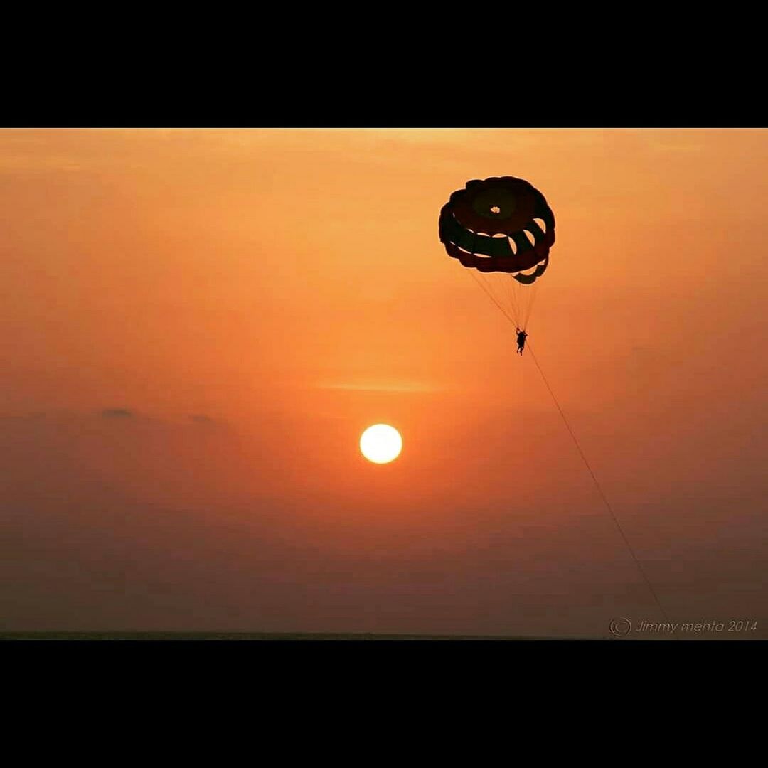 sunset, orange color, sun, silhouette, scenics, mid-air, sky, beauty in nature, transportation, flying, transfer print, parachute, tranquility, auto post production filter, tranquil scene, nature, sport, hot air balloon, idyllic, copy space