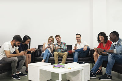 Colleagues using mobile phones at office