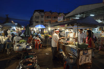 People in market at city during night