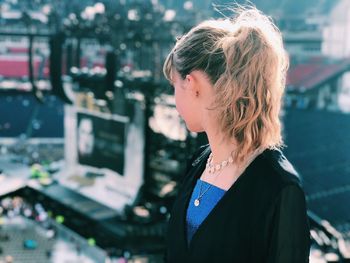 Portrait of young woman looking away outdoors