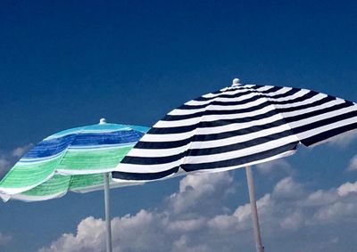 Low angle view of flags against blue sky