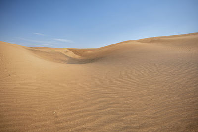 Desert landscape and with large copy space in the blue sky,