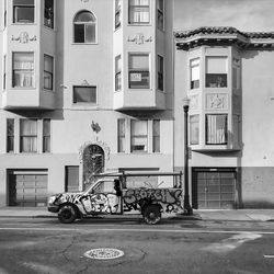 Cars on street by buildings in city