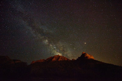 Scenic view of mountain against sky at night