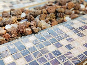 High angle view of stones by tiled floor