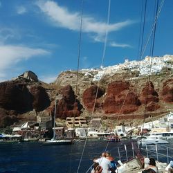Sailboats moored on sea against sky