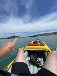 Man on boat in sea against sky