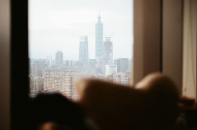 View of city buildings seen through glass window