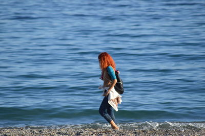 Woman standing at sea shore