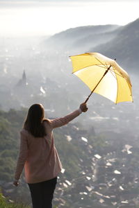 Rear view of woman standing against sky