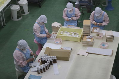 High angle view of people working on table