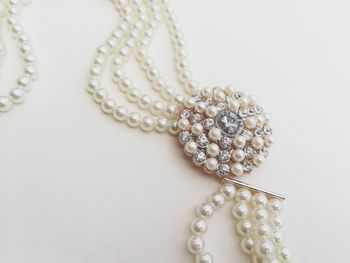 Close-up of necklace on white background