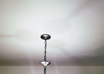 Close-up of electric lamp against wall