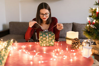 Young millennial woman with christmas presents in a festive atmosphere