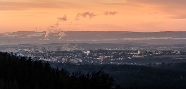 Panoramic shot of cityscape against sky during sunset