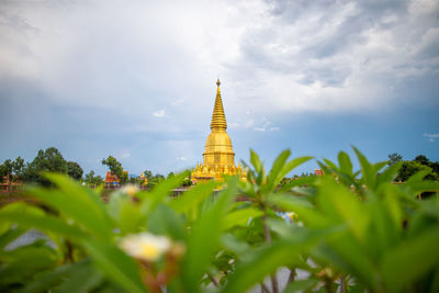 View of temple building against cloudy sky