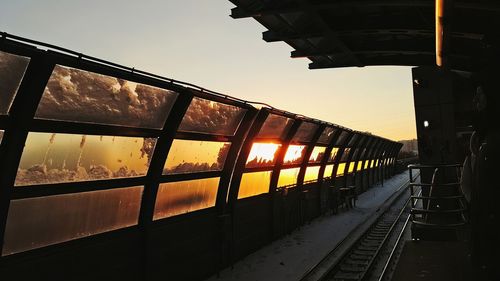 Silhouette bridge against sky during sunset