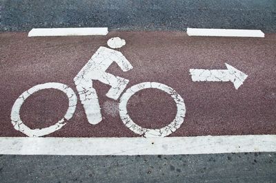 High angle view of arrow sign on road in city