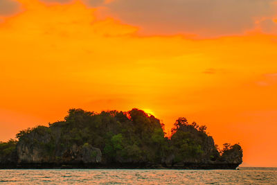 Scenic view of sea against orange sky