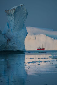 Icebergs on sea against sky