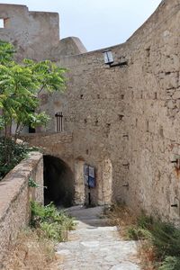 Narrow alley amidst buildings against sky