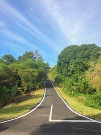 Road amidst trees against sky