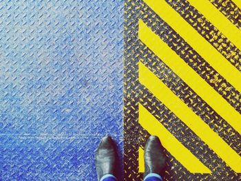 Low section of a man standing on ground