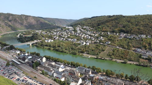 Aerial view of lake and cityscape against sky