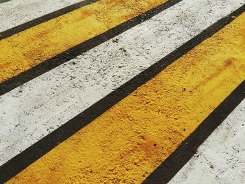 Close-up of yellow road marking on street
