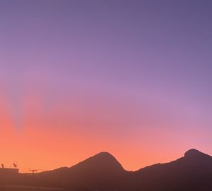 Scenic view of mountains against clear sky during sunset